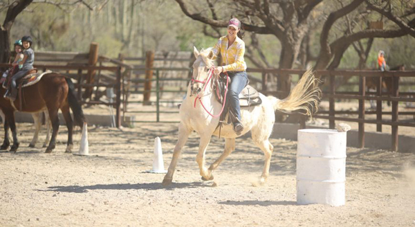 woman at barrel racing lesson at tanque verde ranch in tucson arizona