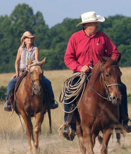 senior couple horseback rides at bucks and spurs guest ranch