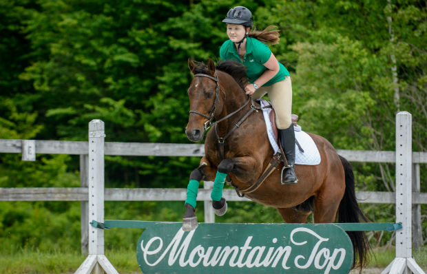 Jumping on a horse at Mountain Top Resort