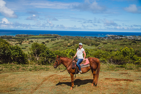 woman riding horse in oahu hawaii at gunstock ranch