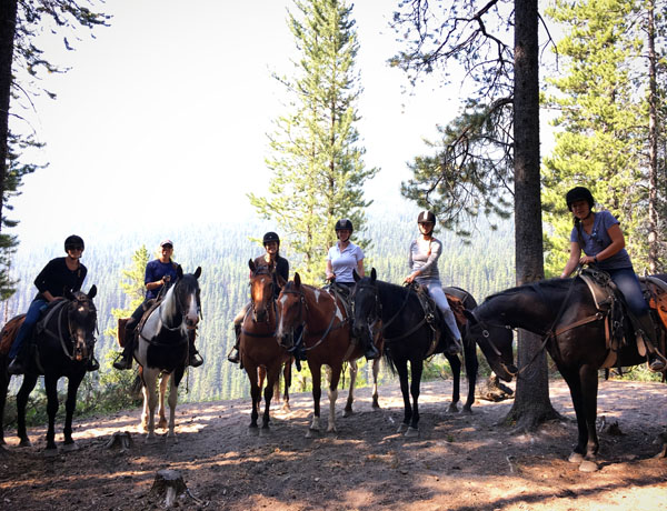 group of friends riding horses in banff national park canada