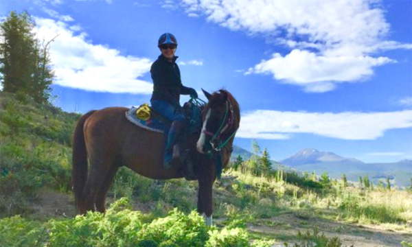 Kate riding her horse in Keystone Colorado