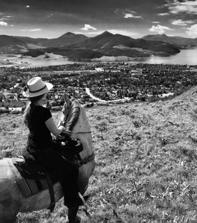 Kate riding her horse and looking down on the town of Keystone Colorado