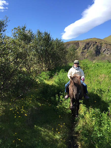 senior woman riding icelandic horse