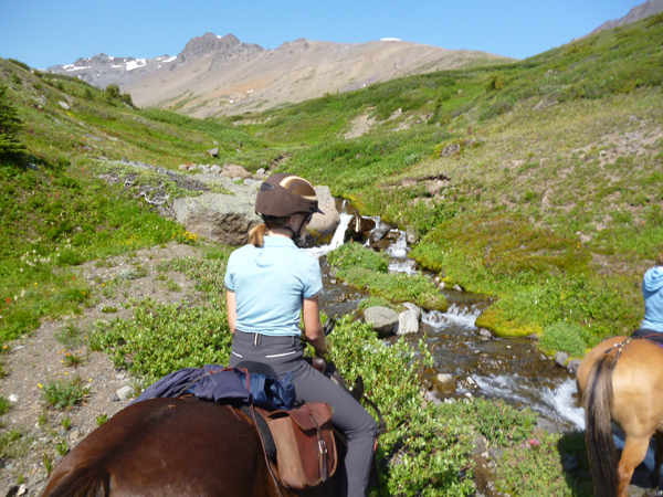 riders crossing alpine rill 
