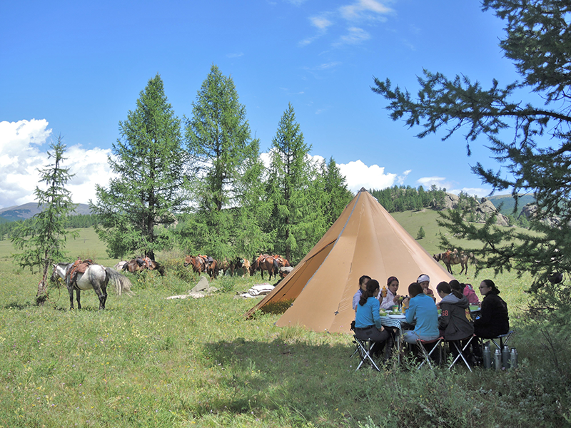 Camping with Stone Horse Expeditions is at scenic sites. Group tents, heated in the cool season, dining tables and pre-dinner wine are part of the signature camping comforts in the wild