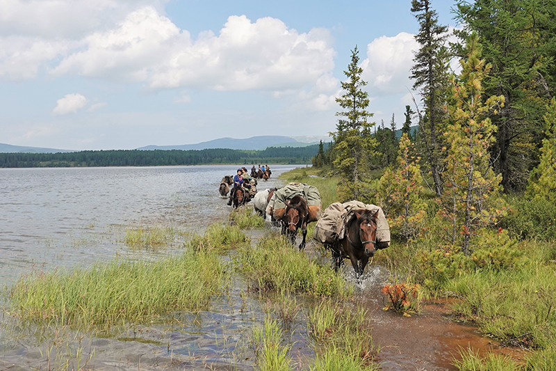 The Stone Horse trek leaving a wilderness lake in the Khentii Mountains