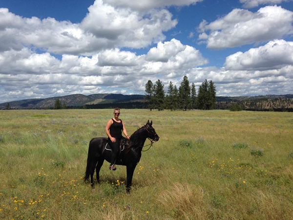 woman riding black saddlebred in riverside state park washington