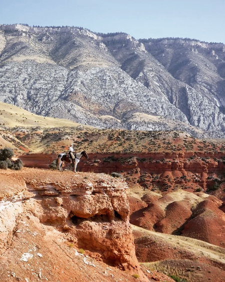 cowboy riding horse at the hideout ranch